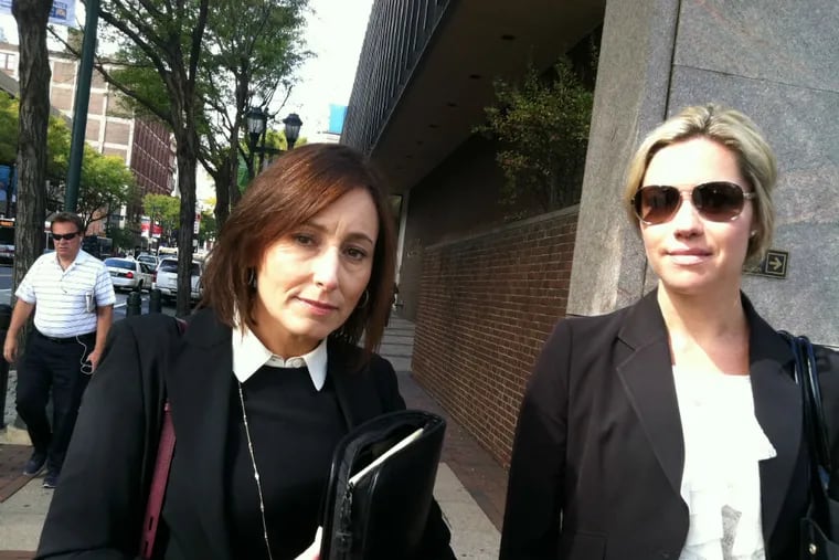Assistant U.S. Attorney Jeanine Linehan (left) and ATF Special Agent Sarah O’Reilly leave the federal courthouse on Market Street, near 6th, after the guilty-plea hearings on Wednesday, Oct. 7, 2015, of Salahudin Shaheed and Basil Buie in the Jewelers Row abduction case. (Julie Shaw / Staff)