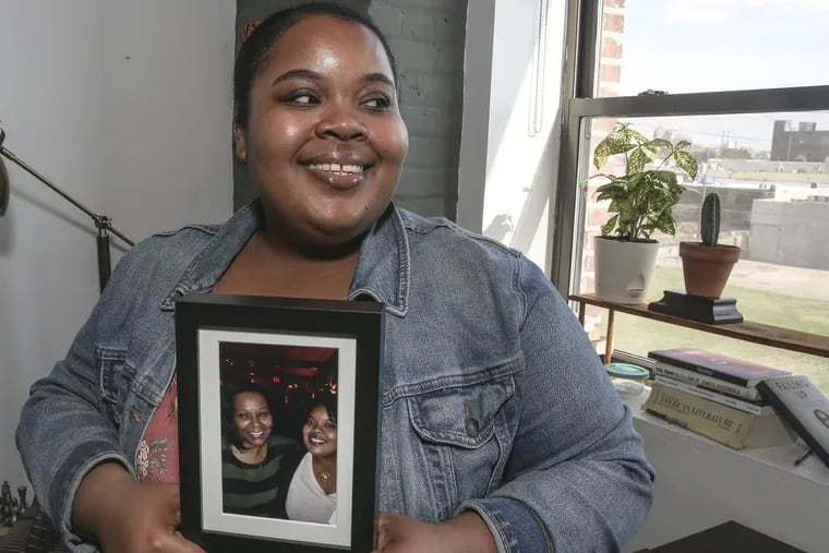 Aunts, or &quot;stand-in&quot; mothers, play a significant role in black families. Amber Burns is sharing her experience with us. Amber with a photo of her and her godmother Sheilah. Tuesday, May 8, 2018.