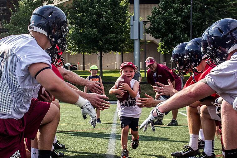 Vhito DeCapria, declared cancer-free in August, leads the Penn football team in smiles.