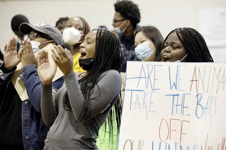 11th graders Keyanna Nurse (left) and Alicia Johnson (right, holding sign) rally with other students and friends of Robeson High School as they demand better conditions in their school.
