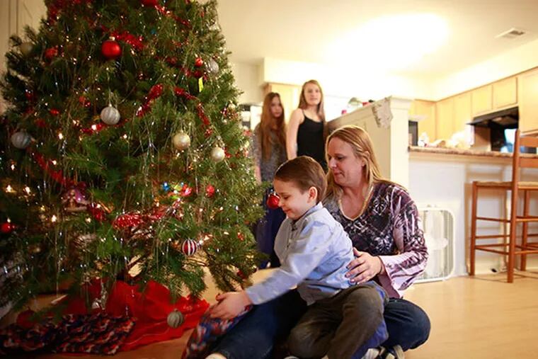 Diane Rhoads, 42, and her children Joseph Cusumado, 4, Anastacia (cq) Cusumado, 11, and Cassidy Cusumado, 9 will spend their first Christmas in their new home in Fairview Village in Phoenixville, December 24, 2013. ( DAVID SWANSON / Staff Photographer )