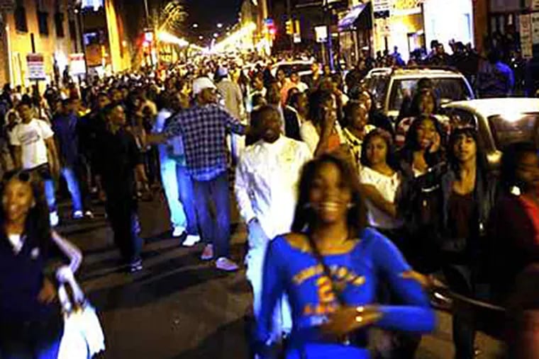 Young people congregate on South Street, part of a gathering that Assistant District Attorney Angel Flores said involved more than 2,000 people were involved in the March 20 incident.
