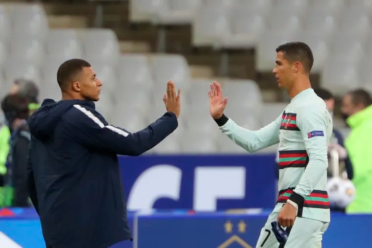 In this Oct. 11 photo, France's Kylian Mbappe and Portugal's Cristiano Ronaldo, right, greet each other before the UEFA Nations League soccer match between France and Portugal at the Stade de France in Saint-Denis, north of Paris, France