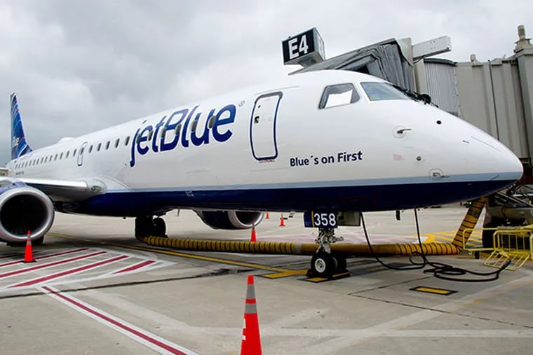 A JetBlue plane sits at the gate at Philadelphia International Airport May 23, 2013 after arriving from Boston's Logan Airport to start the company's service in Philadelphia.  The plane is a new Embraer 190, made in Brazil.  ( CLEM MURRAY / Staff Photographer )