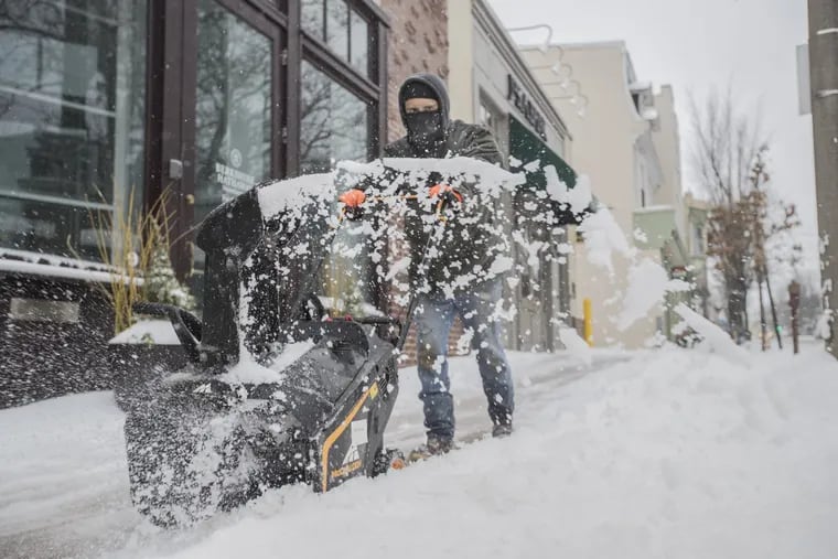 Julio Lamos pushed his snowblower down a Chestnut Hill sidewalk in March 2017.