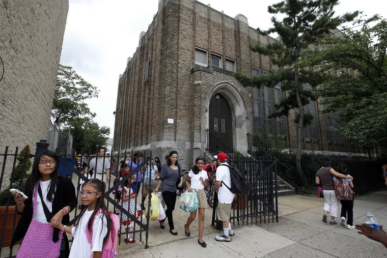 Students and guardians leave the first day of the new school year at the William M. Meredith Elementary School in the Queen Village section of Philadelphia on Monday, September 8, 2014.