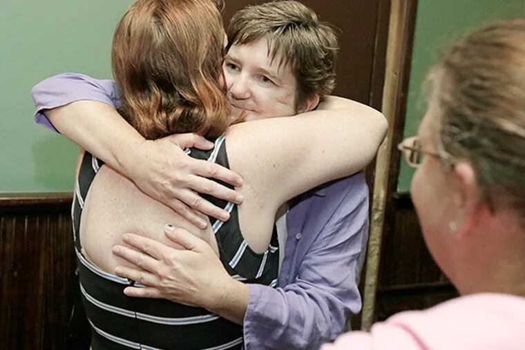 People lined up to hug Margie Winters (facing camera) after meeting at Jacks Firehouse on July 8, 2015. ( ELIZABETH ROBERTSON / Staff Photographer )