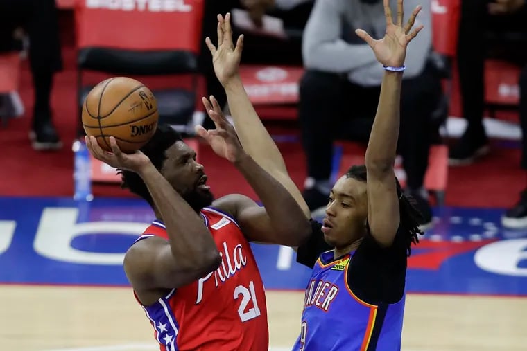 Sixers center Joel Embiid shoots against the Thunder's Moses Brown on Monday.