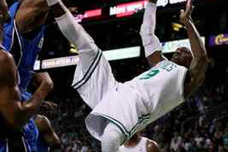 Rajon Rondo takes an acrobatic fall and is fouled after a shot in Game 6 of the Eastern Conference finals. Boston heads tothe NBA Finals after beating Orlando, 96-84, on Friday night.