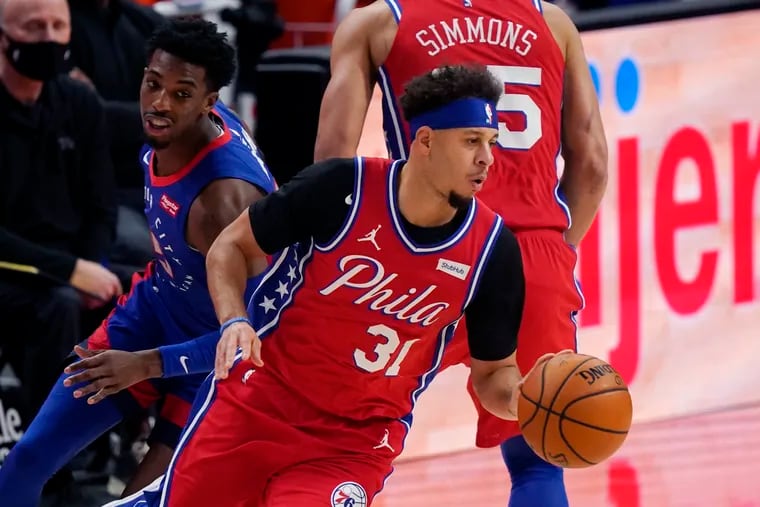 Philadelphia 76ers guard Seth Curry (31) drives as Detroit Pistons guard Delon Wright gives chase during the first half of an NBA basketball game, Saturday, Jan. 23, 2021, in Detroit. (AP Photo/Carlos Osorio)