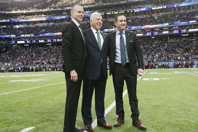 Eagles owner Jeffrey Lurie (center) with executive vice president of football operations Howie Roseman (right) and team president Don Smolenski during a photo opportunity before the Eagles played New England Patriots in Super Bowl LII on Sunday, February 4, 2018 in Minneapolis.