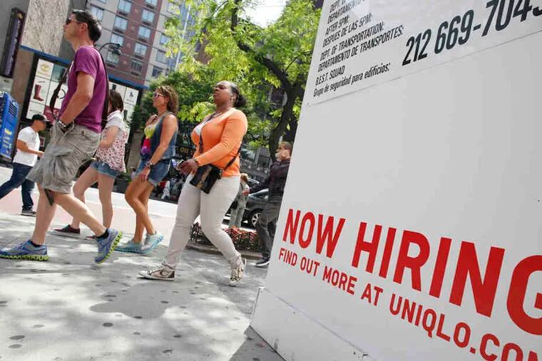 As national layoffs appear to be slowing, a sign in New York solicits job-seekers at the future site of a clothing store.