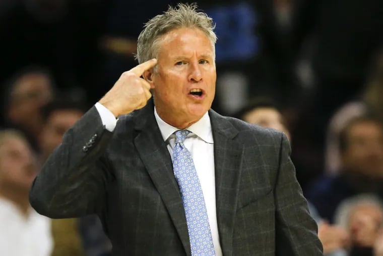 Sixers coach Brett Brown points to his head against the Toronto Raptors on Thursday, December 21, 2017 in Philadelphia.
