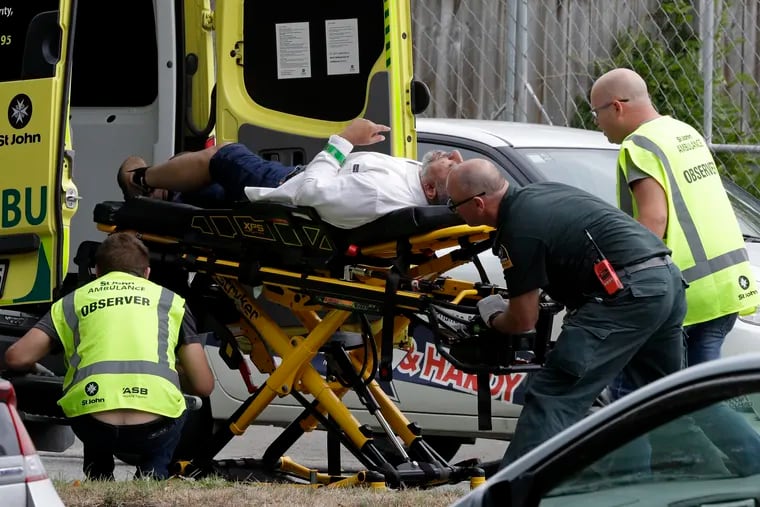 Ambulance staff take a man from outside a mosque in central Christchurch, New Zealand, Friday, March 15, 2019.  Multiple people were killed in mass shootings at two mosques full of worshippers attending Friday prayers on what the prime minister called "one of New Zealand's darkest days," as authorities detained four people and defused explosive devices in what appeared to be a carefully planned attack. (AP Photo/Mark Baker)