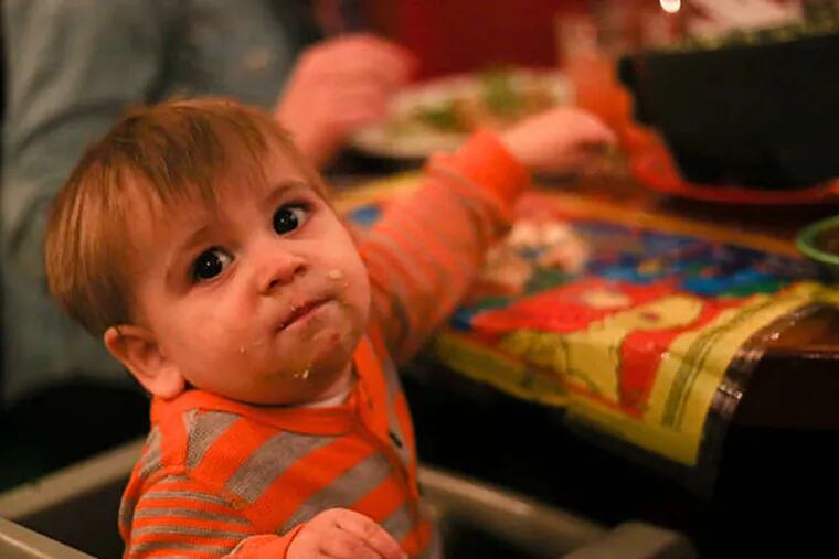 Ike Grodin, 11 months, gives full-face approval of the chips and guacamole at La Calaca Feliz in Fairmount. (ANDREW THAYER / Staff Photographer)