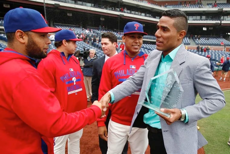 Ricardo Pinto, right, is congratulated by Andres Blanco after being named the Phillies  Minor League Pitcher of the Year before the game against the New York Mets. The Phillies won 3-0.