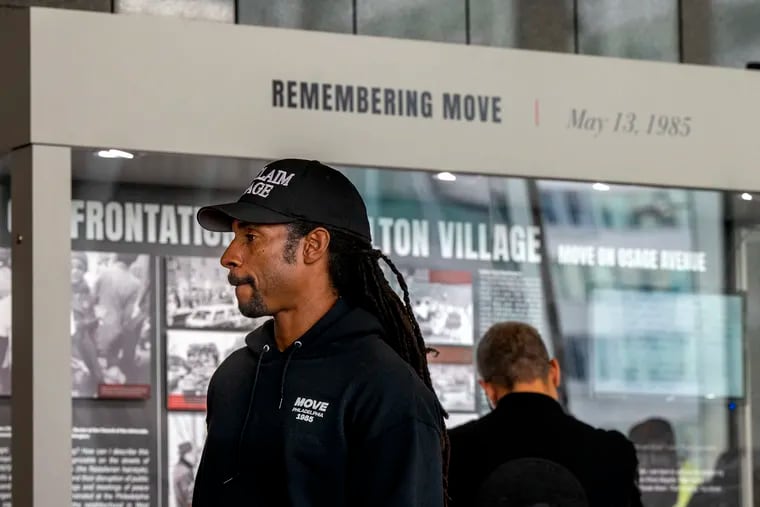 Mike Africa, Jr. pauses in front of the exhibit. He has been at the forefront of efforts to ensure that Philadelphia, and the rest of the US, do not forget the tragic police confrontations of both 1978 and 1985.
