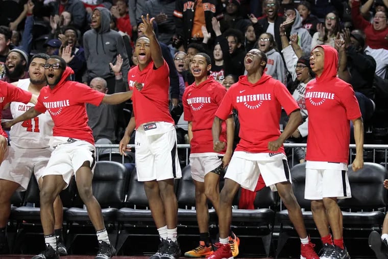 The Coatesville bench clebrates after a 3-pointer by Jhamir Brickus in the 4th quarter against Lower Merion in PIAA District 1 boys basketball semifinals at the Liacouras Center on Feb. 26, 2019.