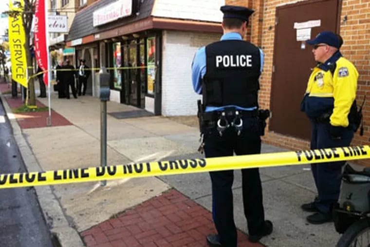 Police outside the William Glatz Jewelry store on Rising Sun Avenue, where an employee and robber were killed in a shootout. (Alejandro A. Alavarez / Staff Photographer)
