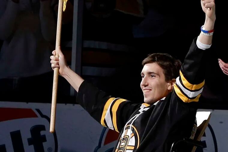 Marathon bombing victim Jeff Bauman reacts as he was honored Saturday as the flag-bearer before Game 2 of a first-round NHL hockey playoff series between the Boston Bruins and the Toronto Maple Leafs.