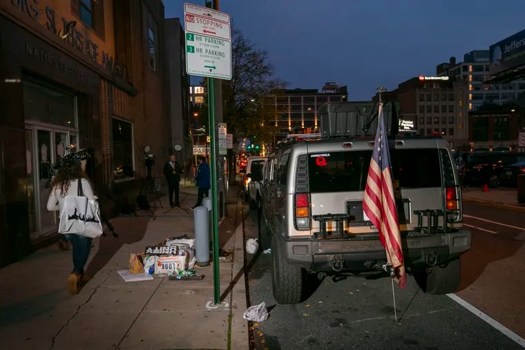 Joshua Macias and Anthony LaMotta drove to Philadelphia in a Hummer displaying QAnon stickers, seen here on N. 13th St. below Vine St. early Friday morning November 7, 2020, near where the 2020 election ballots were being counted. Police recovered guns and ammunition.