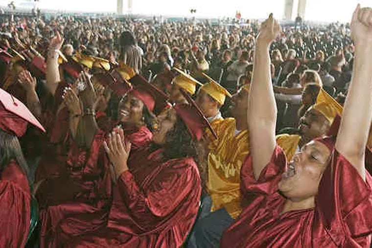 Frances Rivas, 40, of Camden, cheering during Monday's ceremony with her fellow graduates from the Community Education Resource Network.