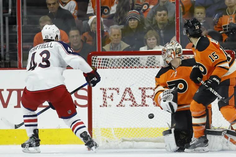 Columbus Blue Jackets' Scott Hartnell, left, scores a goal against Philadelphia Flyers' Steve Mason, center, as Michael Del Zotto looks on during the second period of an NHL hockey game, Saturday, Dec. 5, 2015, in Philadelphia.