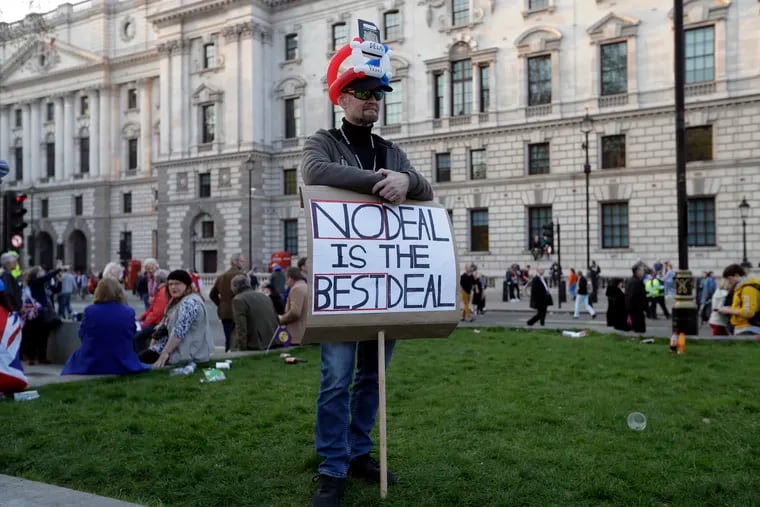 A Brexit supporter holds a sign during a rally after the final leg of the "March to Leave" in London, Friday, March 29, 2019. Pro-Brexit demonstrators were gathering in central London on the day that Britain was originally scheduled to leave the European Union. (AP Photo/ Kirsty Wigglesworth)