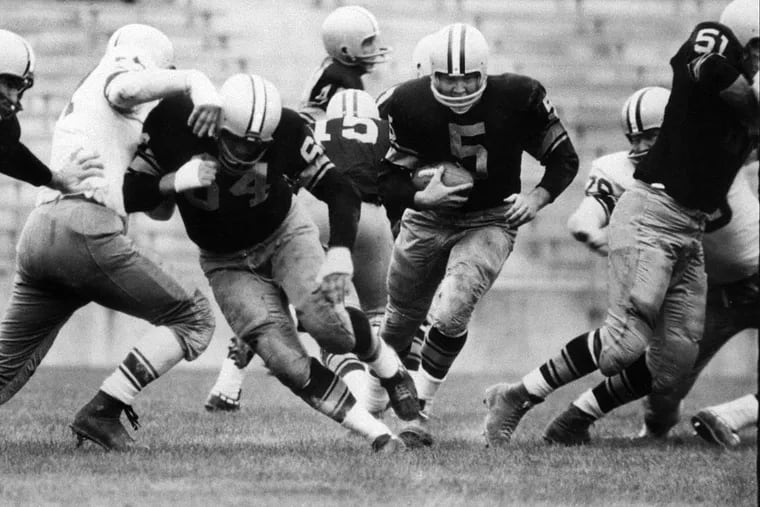 In this 1959 photo, Paul Hornung (5) of the Green Bay Packers goes through the line during a game.