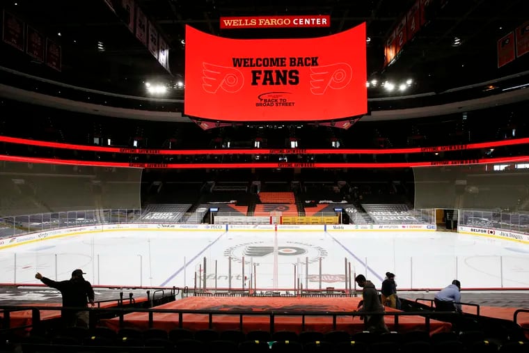 Wells Fargo Center workers prepare the arena for fans on Friday, March 5, 2021.  The Flyers will play the Washington Capitals with fans for the first time this season on Sunday. The Flyers and Sixers will allow 3,100 fans in the arena for games.