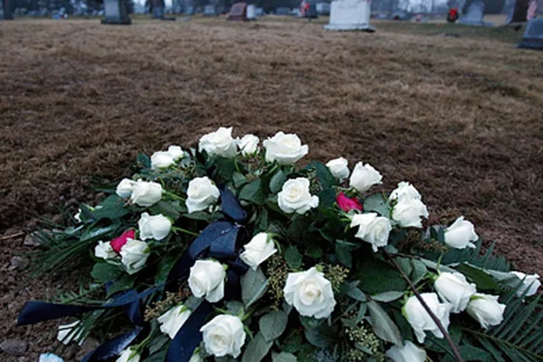 Flowers that adorned Joe Paterno's casket lie on what is likely his burial site at Spring Creek Presbyterian Cemetery near the Centre Hills Country Club. (David Maialetti / Staff Photographer)