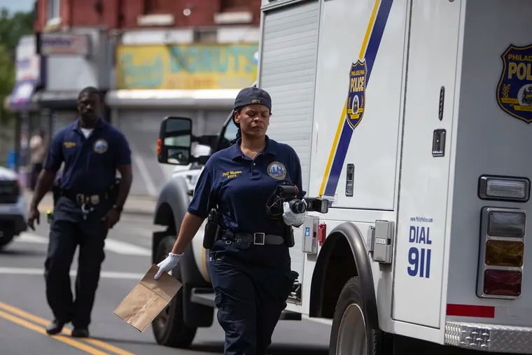Philadelphia Police and the crime scene unit investigate a shooting that occurred on the 2300 block of Ridge Ave. in Northwest Philadelphia on Saturday, June 15, 2019.