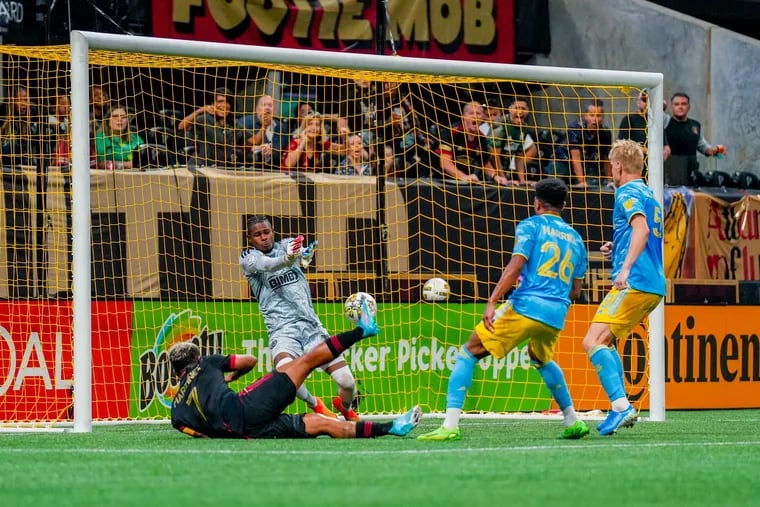 Andre Blake (center) made five saves in the Union's scoreless tie in Atlanta, including this diving stop on the goal line against Atlanta United's Josef Martínez (left) in second-half stoppage time.