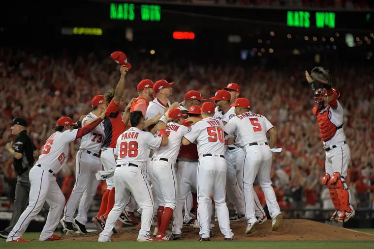 The Washington Nationals celebrate after defeating the Milwaukee Brewers in the National League Wild Card game Tuesday night.