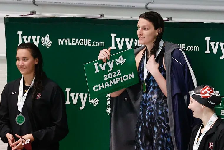 University of Pennsylvania's Lia Thomas wears her medal after winning the women's 200 yard-freestyle race during the Women's Ivy League Swimming and Diving Championships Friday. Thomas won the race with a time of 1:43.12.  Harvard swimmers Samantha Shelton (left) and Molly Hamlin place second and third, respectively.