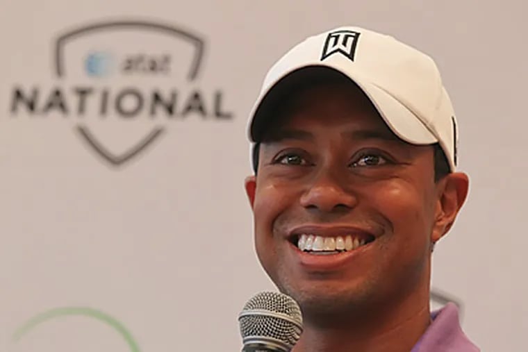 Tiger Woods smiles as he answers questions at a press conference for the AT&T National. (Michael Bryant/Staff Photographer)