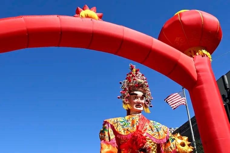 April 3, 2023: Giant figures of the gods parade through an arch at the Hoyu Folk Culture Festival in Chinatown, celebrating a tradition from China’s Fujian province.