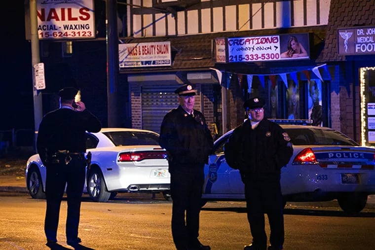 Philadelphia police officer guard the scene at an officer-involved shooting on Dec. 15, 2014. The shooting took place in front of Geiger's Bakery 6600 block of Frankford Ave in Mayfair section of the city. ( ALEJANDRO A. ALVAREZ / STAFF PHOTOGRAPHER )