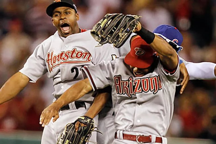 Houston's Michael Bourn, Arizona's Chris Young and Chicago's Marlon Byrd celebrate after the final out. (Chris Carlson/AP)