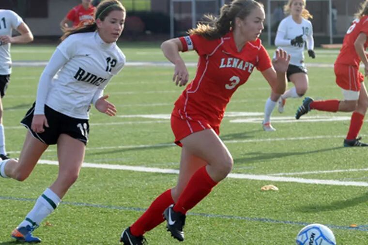 Lenape’s Katie Rigby (right) races ahead of a Ridge player during the state Group 4 final Nov. 19. Rigby scored a goal in the Indians’ 2-0 win; she had 21 goals and 15 assists overall. (Curt Hudson / For The Inquirer)