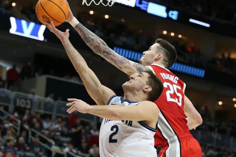 Collin Gillespie, left, of Villanova has his shot blocked by Kyle Young of Ohio State.