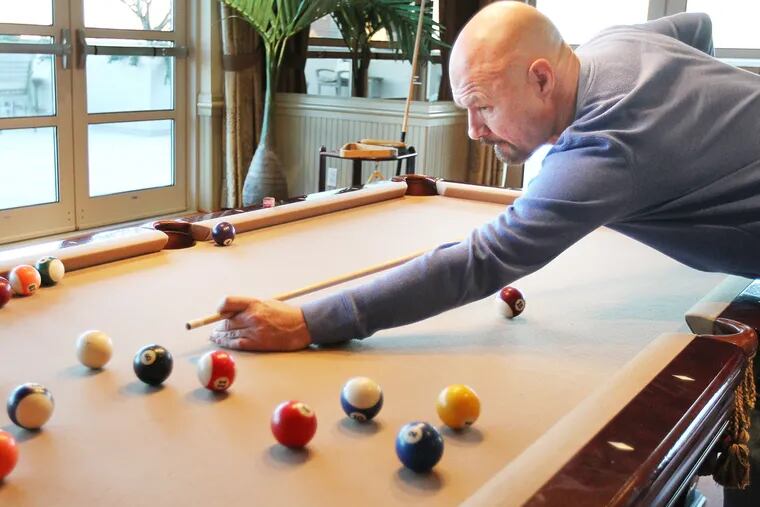 Tony Bruno plays pool at his home at the Dockside Condos in Philadelphia on November 24, 2013. ( DAVID MAIALETTI / Staff Photographer )