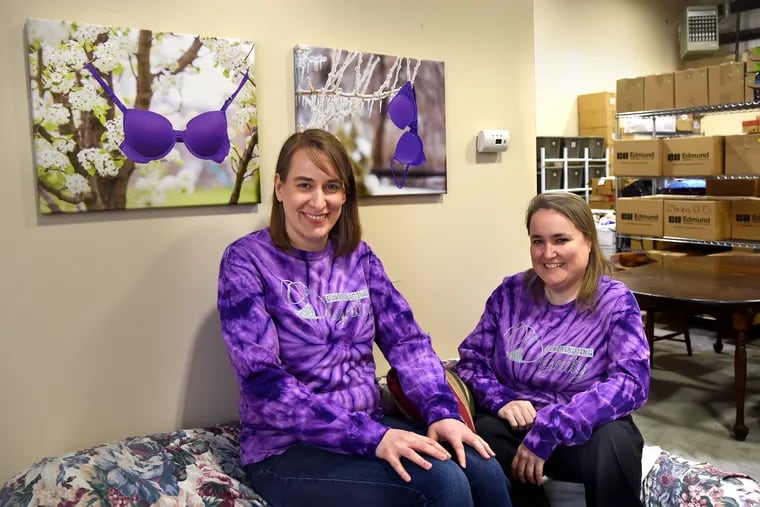 Rebecca McIntire (left) and Joanie Balderstone (right) in the Cherry Hill warehouse of Distributing Dignity, a nonprofit that supplies needy women with new under-garments and personal-hygiene products at no cost.