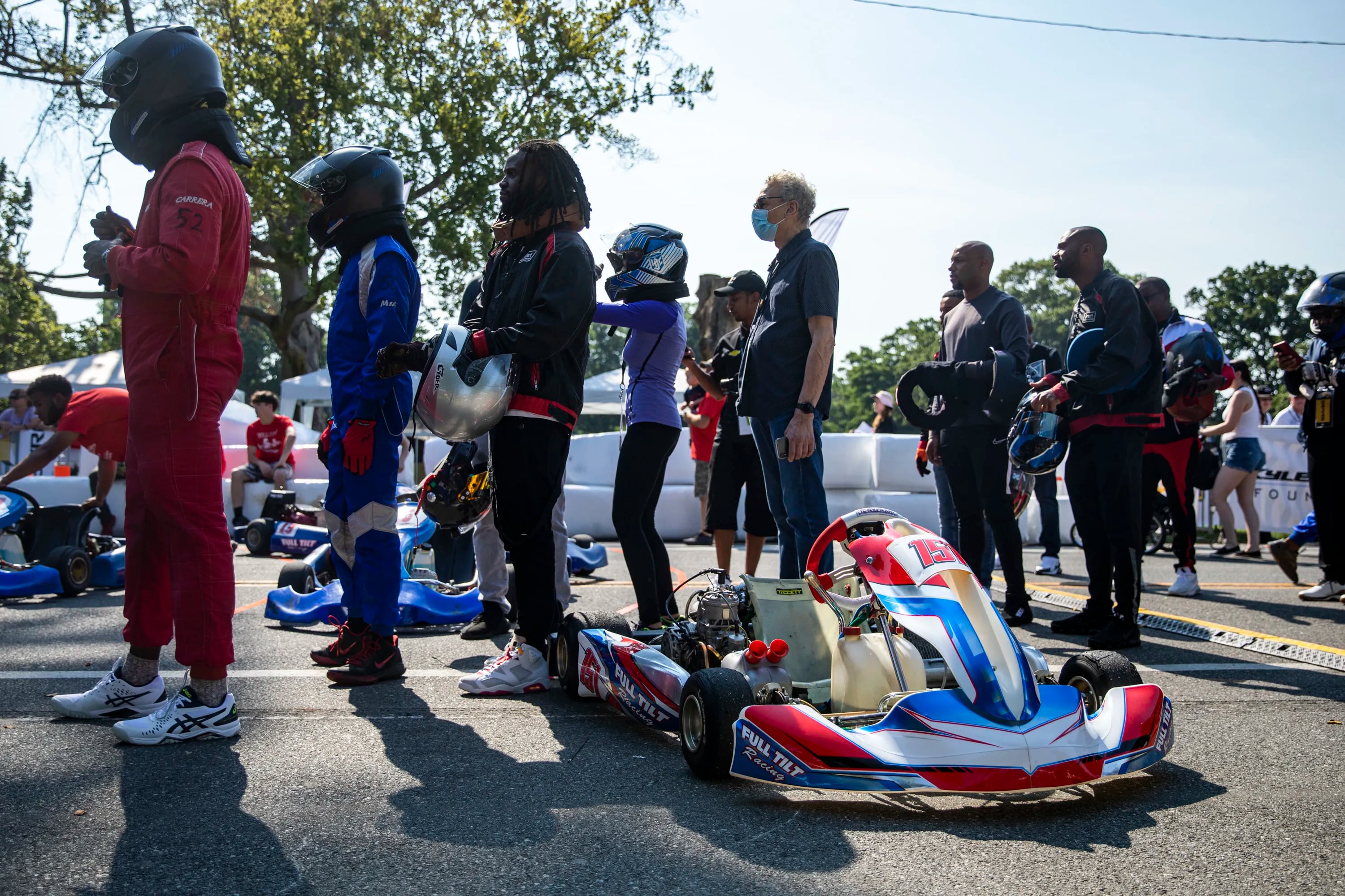 People line to hit the track on some racing carts in front of the Please Touch Museum in Philadelphia on Friday.


