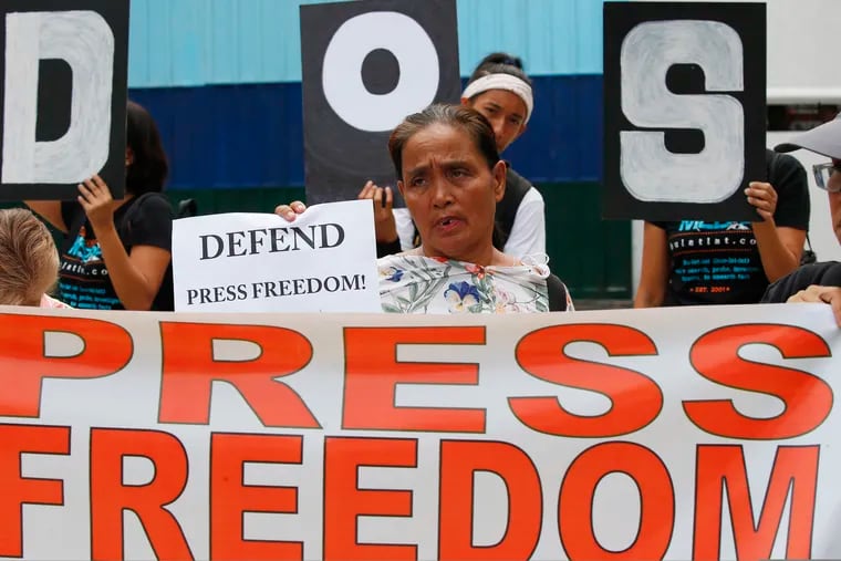 In this May 3, 2019 photo, protesters rally outside the armed forces headquarters to mark World Press Freedom Day, which was declared by the UN General Assembly in Manila, Philippines. The Philippine government’s chief lawyer is asking the Supreme Court to shut down the country’s largest TV network by revoking its operating franchises because of alleged constitutional violations, in a move critics call an attempt to muzzle the media.