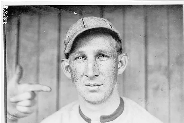 Photograph shows (Harvard) Eddie (Edward Leslie) Grant, third baseman for the Cincinnati Reds, head-and-shoulders portrait, facing front, with another person's left hand and index finger pointing at Eddie's head. Thompson may have been unaware that Grant began the 1911 season with the Cincinnati Reds and did not play a single game for the Philadelphia Phillies. (c1911 May 13) SOURCE: Library of Congress
