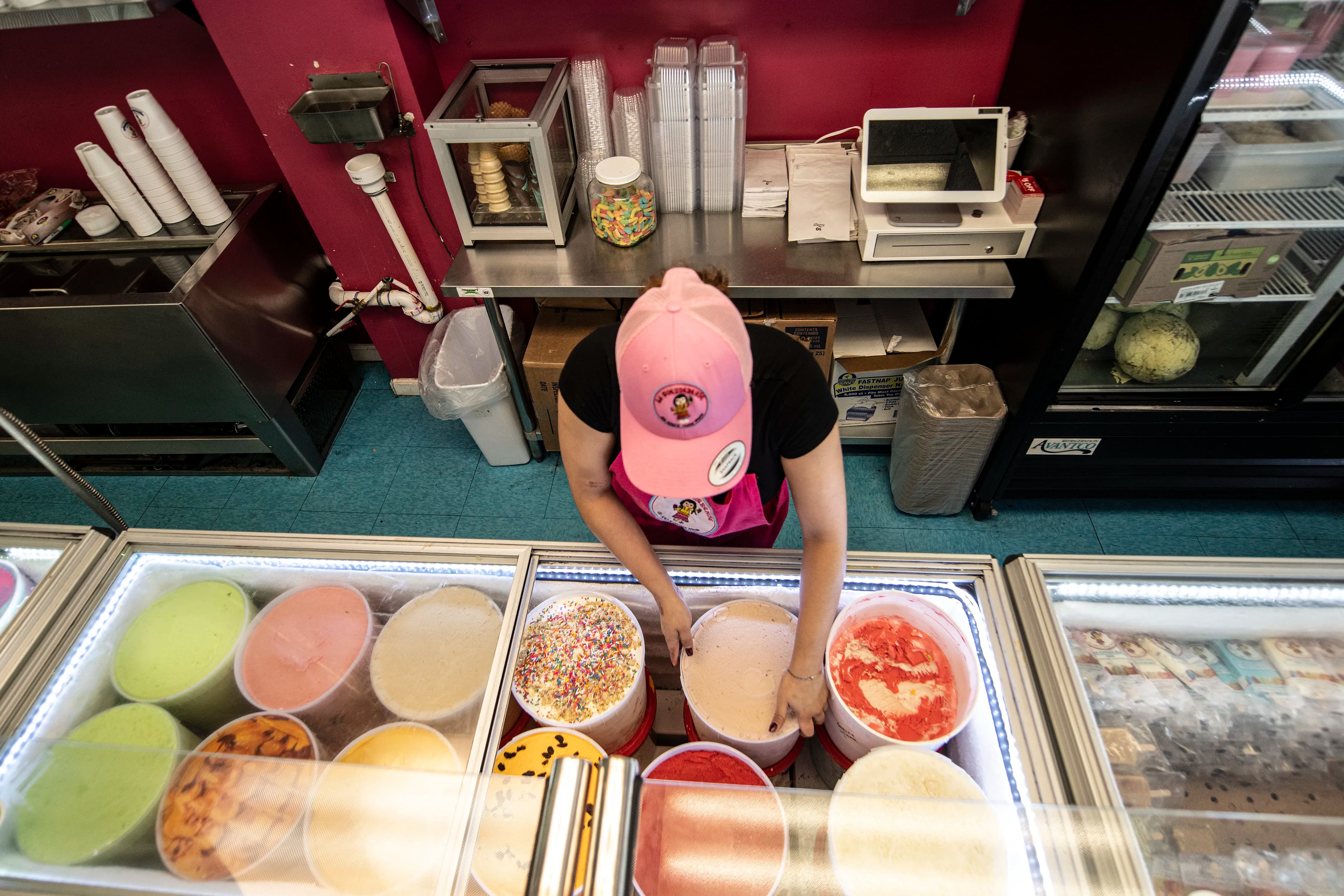 Mireya Rosa Chavez works behind the counter at La Guerrerense Ice Cream Inc in Stanton, Delaware. The Rojas family has been operating in Philly's Italian Market since 2016, serving over 100 Mexican-style ice creams and paletas to a growing community. 