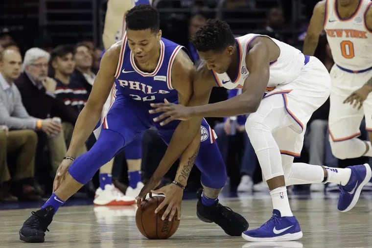 Markelle Fultz (left) and the Knicks' Frank Ntilikina battle for the ball during the first half.