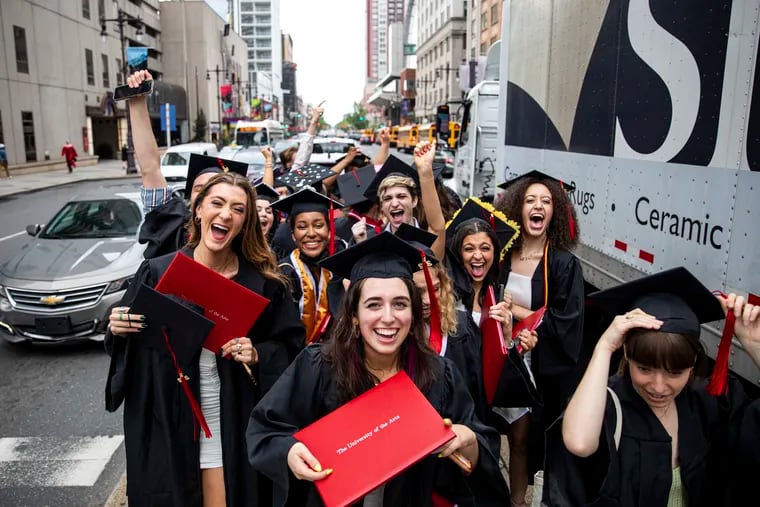 Caroline O’Connell (front center), graduate in fine arts and musical theater, poses with fellow friends and classmates after graduating from the University of the Arts at the Academy of Music in 2022.