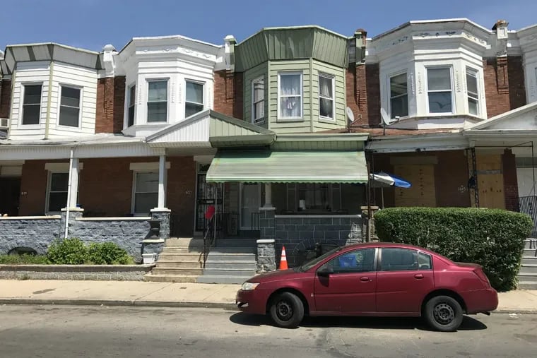 The 600 block of South 55th Street in West Philadelphia was calm on Friday after a shooting took place the previous night outside the home with the green awning.